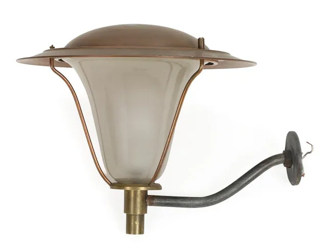 “Tommylygte”. A galvanized metal and brass outdoor wall lamp with copper top shade and frosted glass inner shade. Model 38527–27. Manufactured by Louis Poulsen. 1960s. H. 34. Diam. 40 cm.
