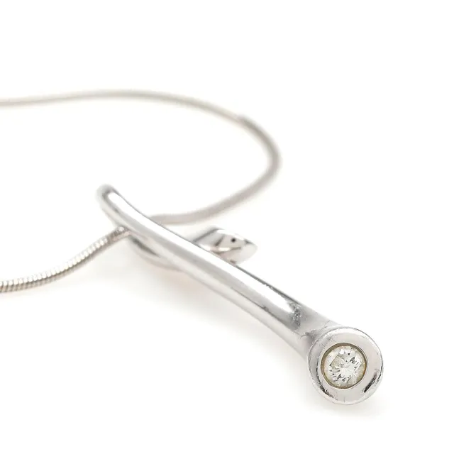 A “Magic” diamond pendant set with two brilliant-cut diamonds weighing a total of 0.13 ct, mounted in 18k white gold. Colour: F-G. Clarity: VS. Manufactured by Georg Jensen. And a 14k white gold necklace. Weight app. 8 g. L. 3.2 and 50 cm.