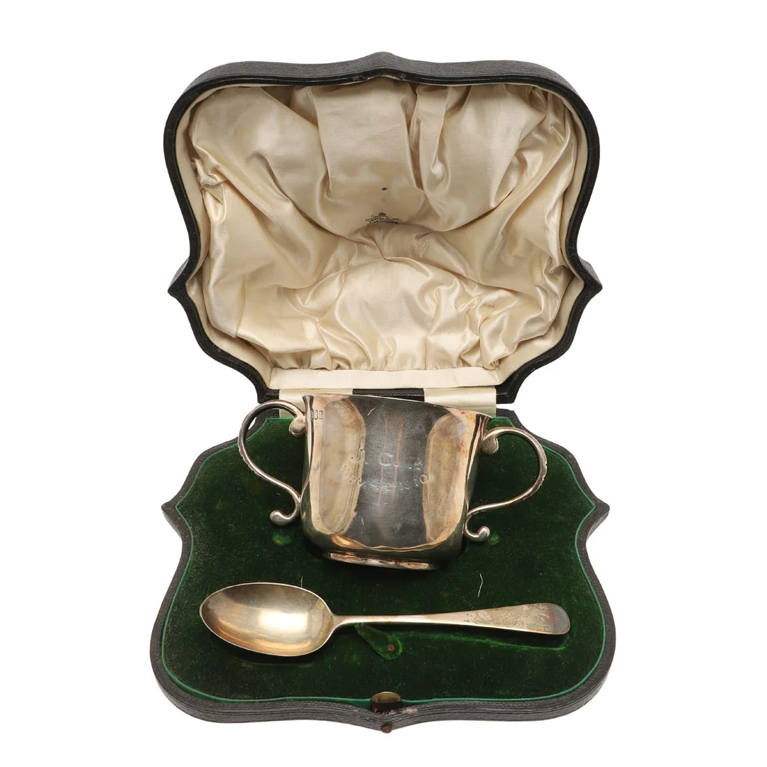 AN EARLY 20TH CENTURY CASED SILVER TWO-HANDLED CUP & SPOON. — Silver — Lawrences Auctioneers