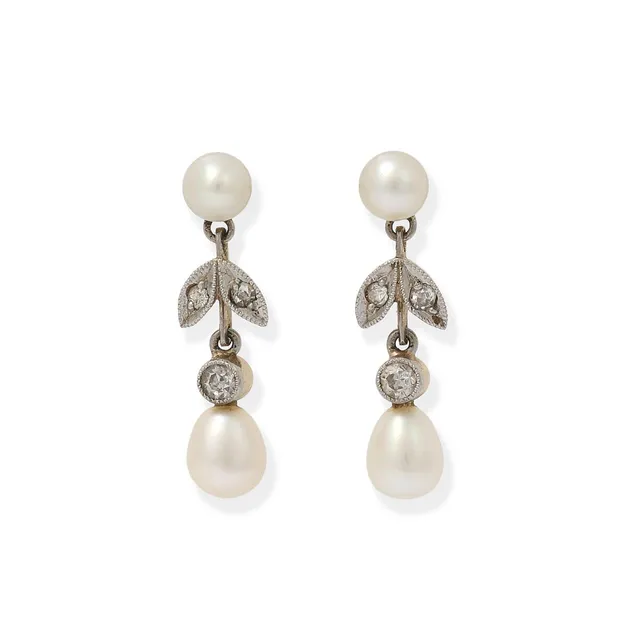 A pair of pearl and diamond eat studs each set with two cultured pearls and old-cut diamonds, mounted in 14k gold and platinum. Weight in total app. 1.7 g. L. 17 mm. (2)