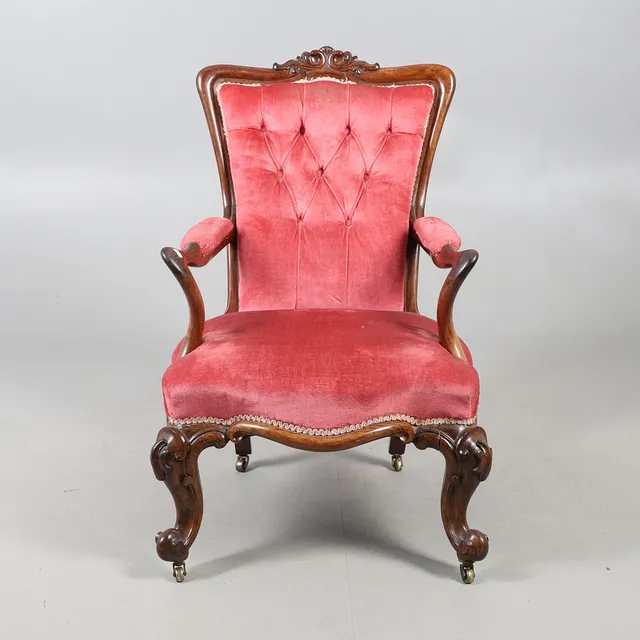 A VICTORIAN CARVED ROSEWOOD OPEN ARMCHAIR.