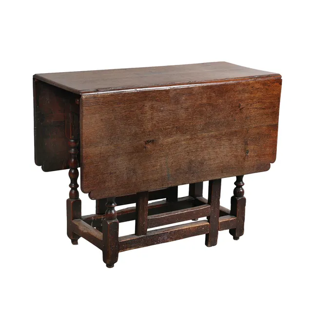 A CHARLES II OAK DROP LEAF TABLE.