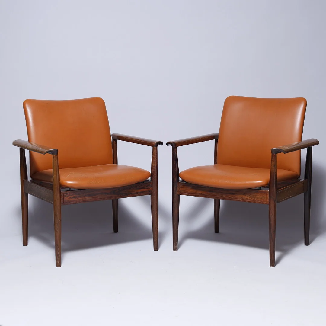 FINN JUHL. Et par "Diplomat" armstole, stel af palisander, sæde og ryg betrukket med cognacfarvet skind, France & Søn, Model FD 209, Danmark, 1960erne, (2). — Armchairs & Chairs — Palsgaard Kunstauktioner