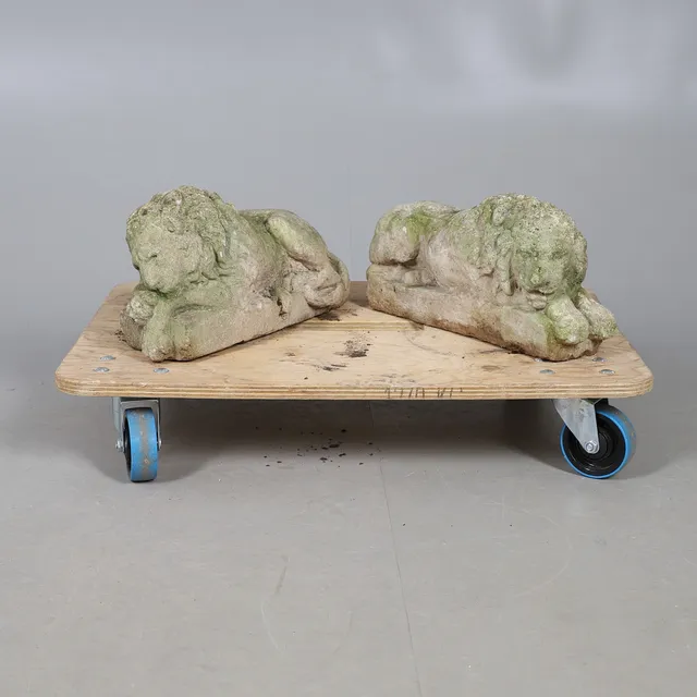 A PAIR OF RECONSTITUTED STONE LIONS.