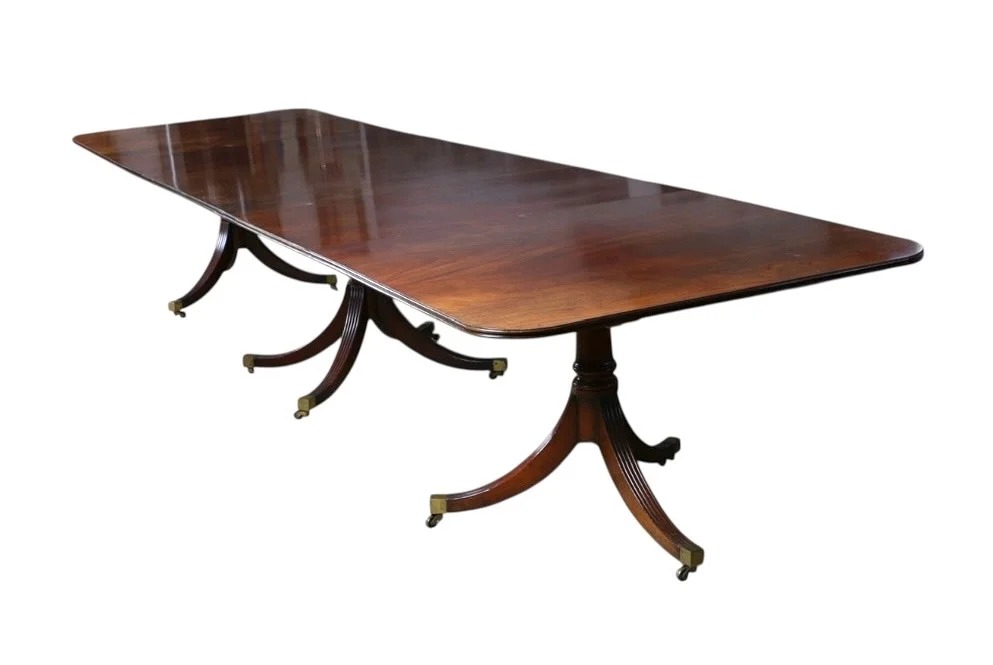 A VERY LARGE GEORGE III STYLE MAHOGANY TRIPLE PEDESTAL DINING TABLE MADE BY RESTALL BROWN & CLENNELL. — Tables — Bishop & Miller