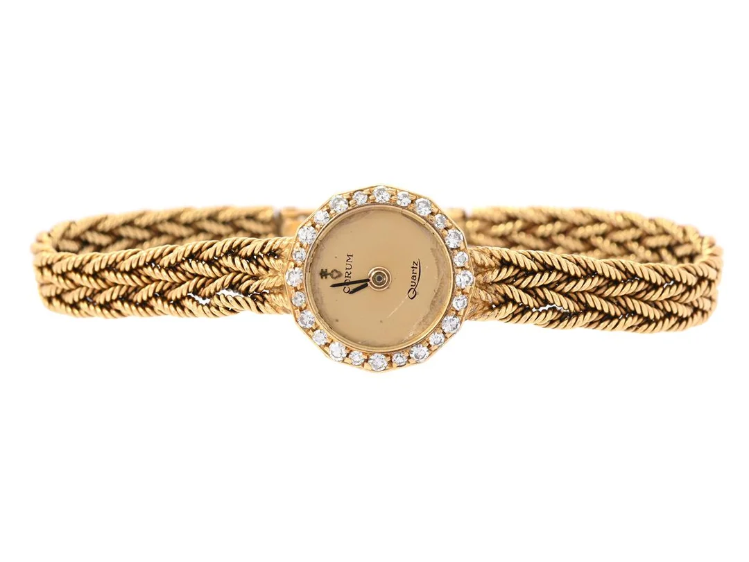 CORUM, damur, 15 mm, Boett nr. 776, 18K guld, quartz, safirglas (repor), diamantkrans (24 st. 8/8, TW/VS, ca 0,30 ctv), skadad urtavla, integrerad originallänk, längd 150-155 mm, totalvikt 18,5 gram, ca 1985. — Klockor/Corum — Kaplans