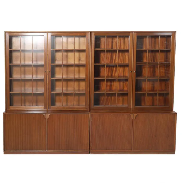 A pair of mahogany display cabinets. Front with two glass doors, interior fitted with adjustable shelves and two fluted doors. Manufactured by Illums Bolighus. 1940s. H. 180. W. 130. D. 42 cm. (2)