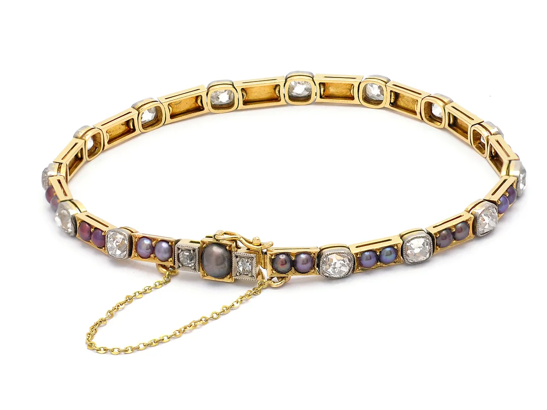 ARMBAND, 18K guld, 16 gammalslipade diamanter ca 5,00 ctv, ca TW/SI, 31 odlade halvpärlor, ca 2,5 mm, en pärla ca 4,7 mm, låset stämplat Bergman handelsaktiebolag, Stockholm 1927, längd ca 19 cm, vikt 12,4 g, säkerhetskedjan stämplad 14K guld. — Smycken/Armband — Kaplans