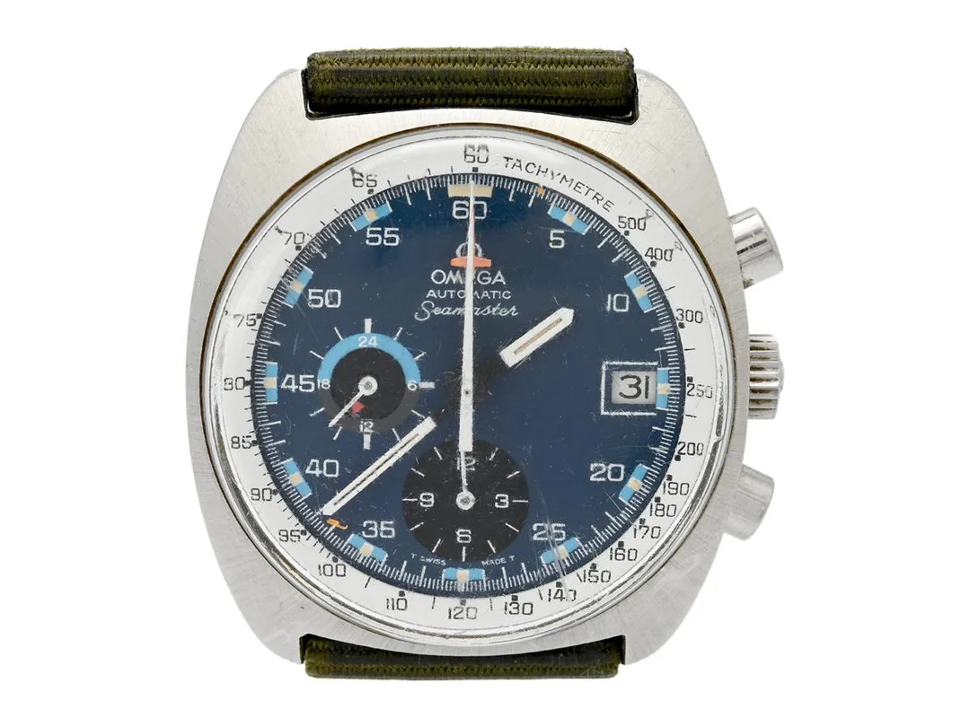 OMEGA, Seamaster (T Swiss Made T), "Tachymetre", Cal 1040, Serie nr. 36267936, Ref nr. ST 176.0007, Boett nr. 176.007, kronograf, herrur, 38,5 mm, stål, automatisk, plexiglas, datum, 24-timmarsvisning, skadad urtavla, defekt (akut servicebehov), tygband,ca 1973. — Klockor/Omega — Kaplans
