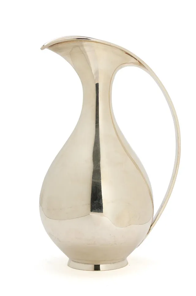 Sterling silver pitcher with smooth surface. Manufactured and stamped by A. Michelsen, with date letter E9=1955. Weight 672 g. H. 24.2 cm.
