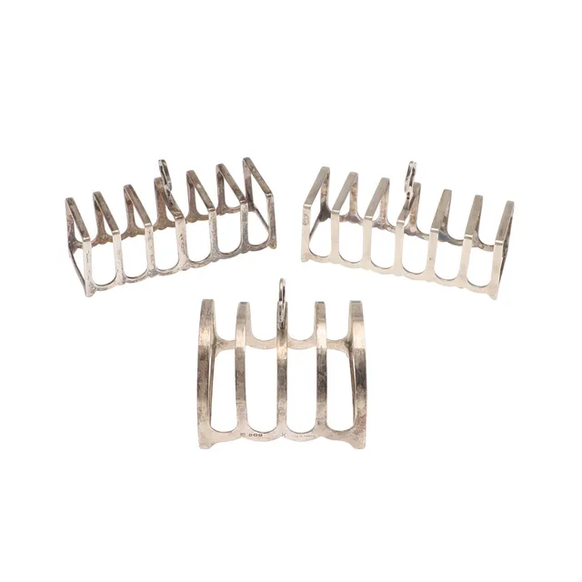 A PAIR OF EARLY 20TH CENTURY SILVER TOAST RACKS AND ANOTHER.