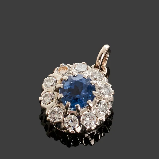 CARMOSÉHÄNGE, 18k vitguld, centrerad safir ca 0.70ct bekransad med briljantslipade diamanter totalt ca 0.30ct.