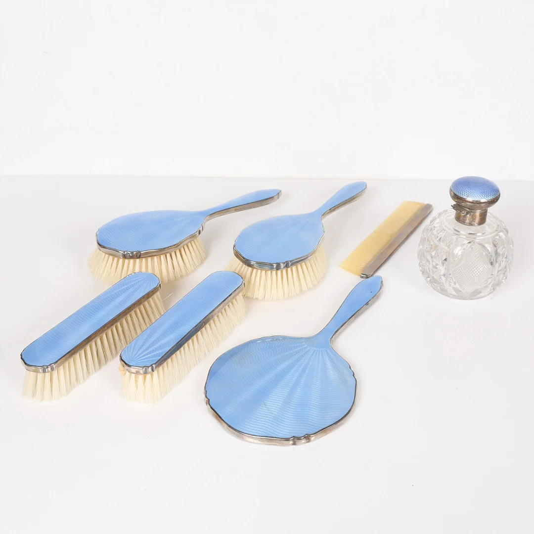 A SILVER AND GUILLOCHÉ ENAMEL SCENT BOTTLE AND AN ENAMEL DRESSING TABLE SET (7). — Silver — Bishop & Miller