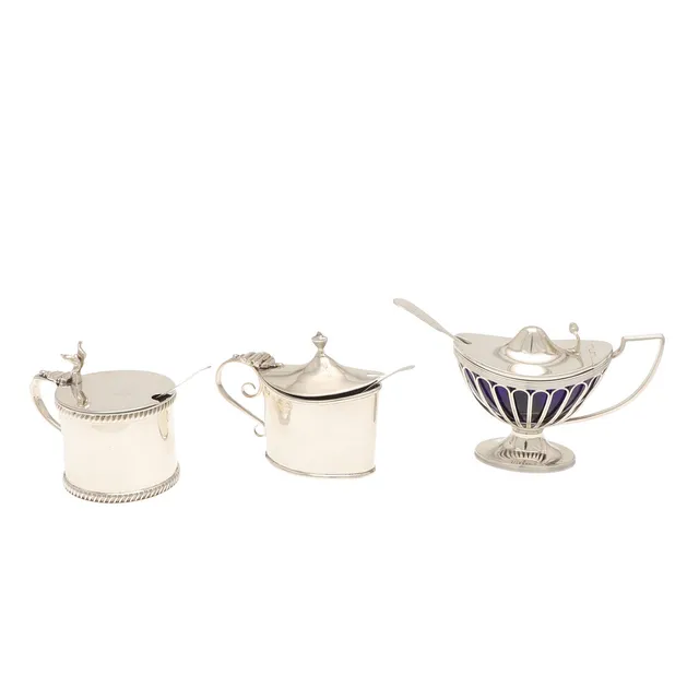THREE SILVER MUSTARD POTS.