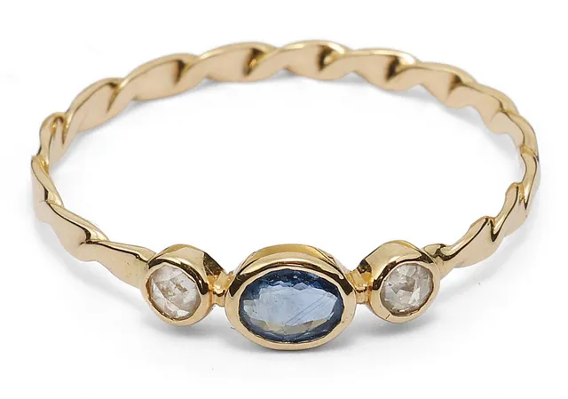 A spahire and diamond ring set with an oval-cut sapphire and two rose-cut diamonds mounted in 18k gold. Size 55.5.
