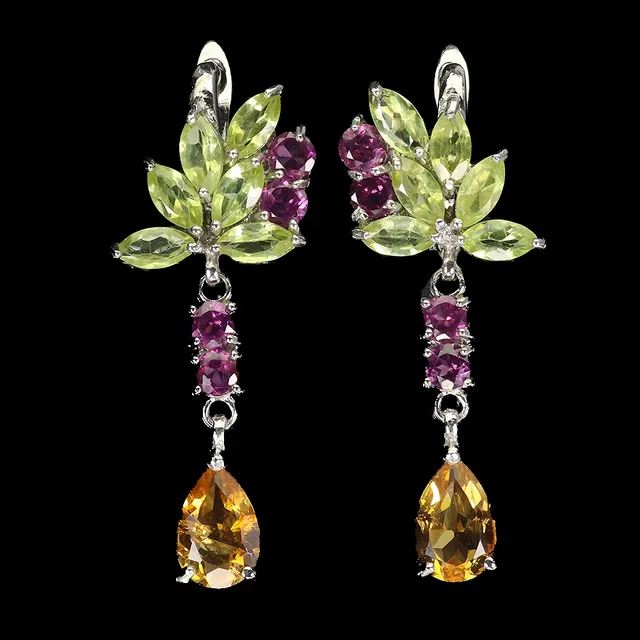 Stud earrings in rhodium-plated sterling silver adorned with each larger citrine as well as numerous periodots