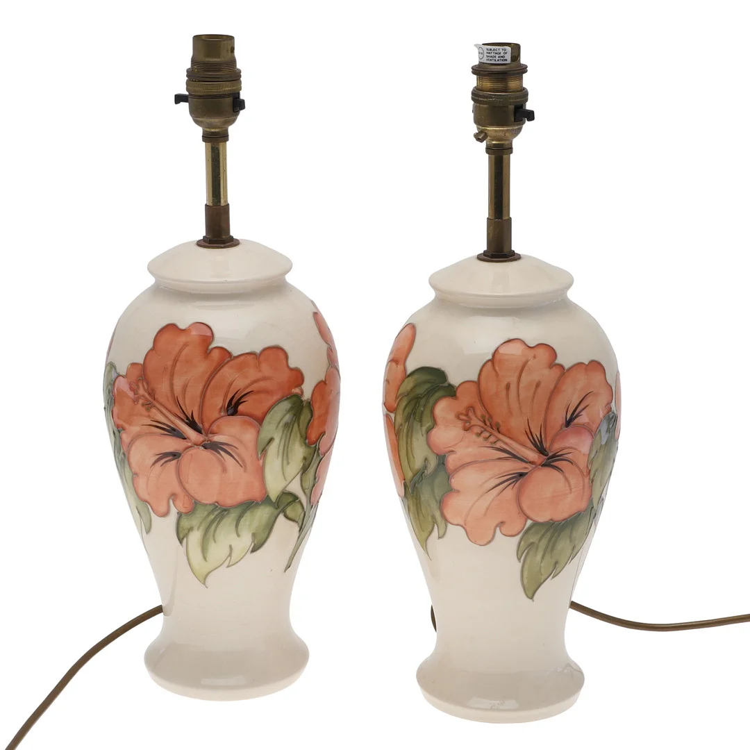 A PAIR OF MOORCROFT HIBISCUS PATTERN TABLE LAMPS. — European — Lawrences Auctioneers