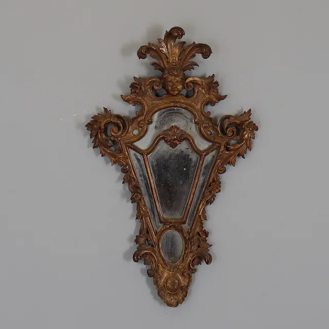 A VENETIAN GILTWOOD MIRROR.