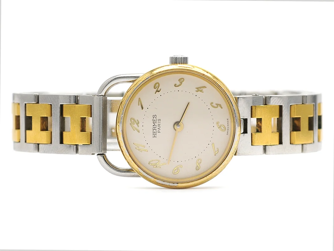HERMES, Paris, damur, 25 mm, bicolour, quartz, mineralglas, datum, skadad urtavla, integrerad originallänk (skadad), längd 165-170 mm, ca 1992. — Klockor/Hermès — Kaplans