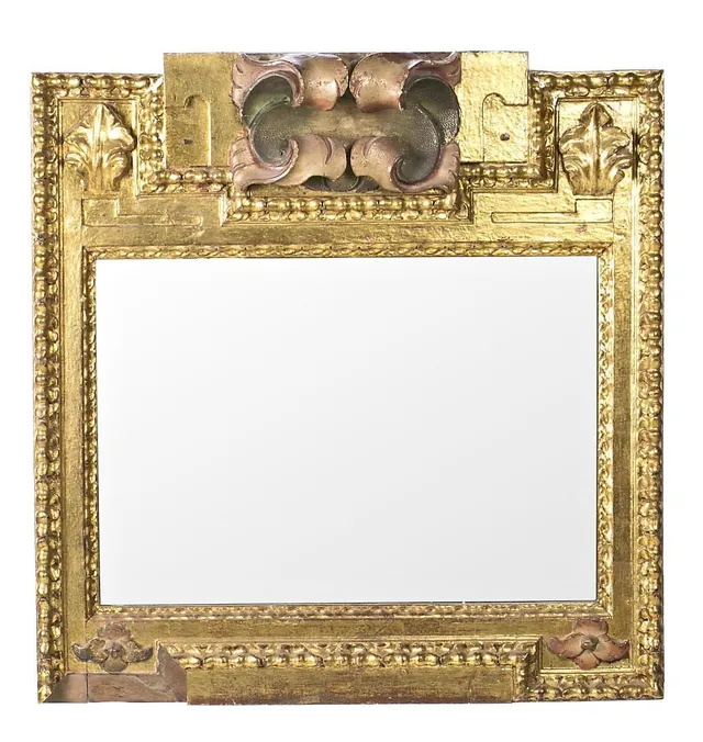 Spanish mirror with frame in carved, painted and gilt wood, made with altarpiece fragments, 17th Century.
