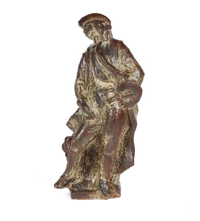 Helge Christoffersen for Royal Copenhagen. Artist with palette. Stoneware figurine with sung glaze.