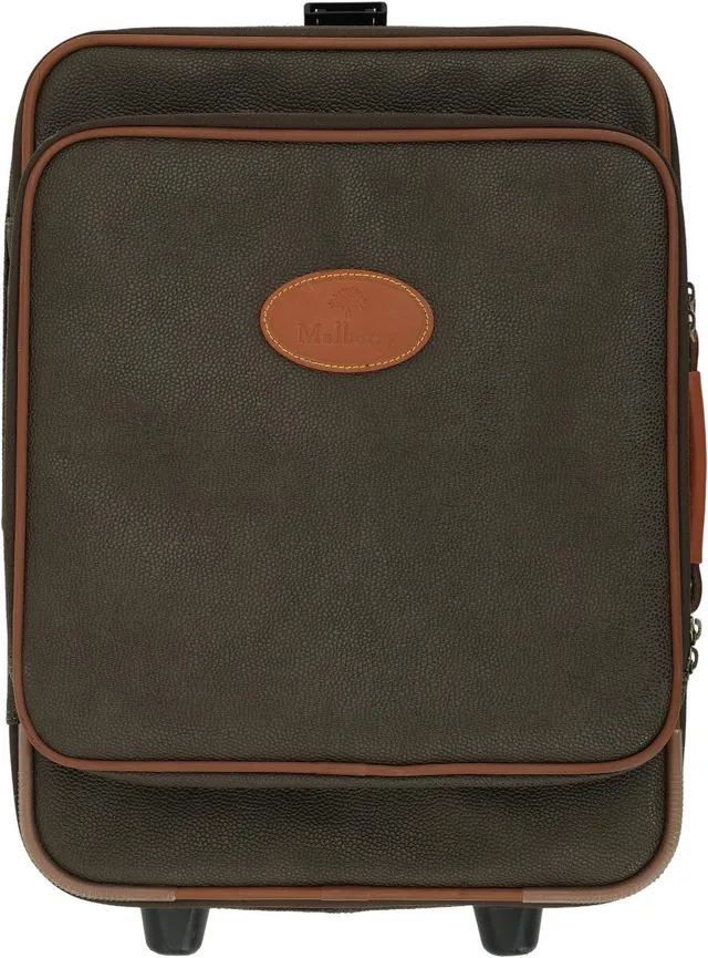 A “Heritage” trolley of brown Scotchgrain leather with brown leather trim, a top handle, an extendable handle, an exterior zippered compartment with two interior pockets, and a central exterior zippered compartment with an interior zippered pocket, as well as a buckle strap and checked microfiber lining. H. 50 × W. 42 × D. 22 cm.