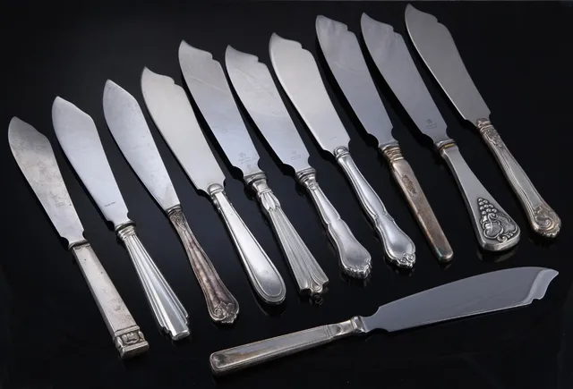 Cohr et al. A collection of layer cake knives with silver handles (11)