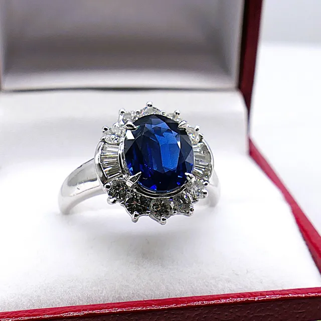 DEEP SAPPHIRE AND DIAMOND HALO COCKTAIL RING IN PLATINUM.