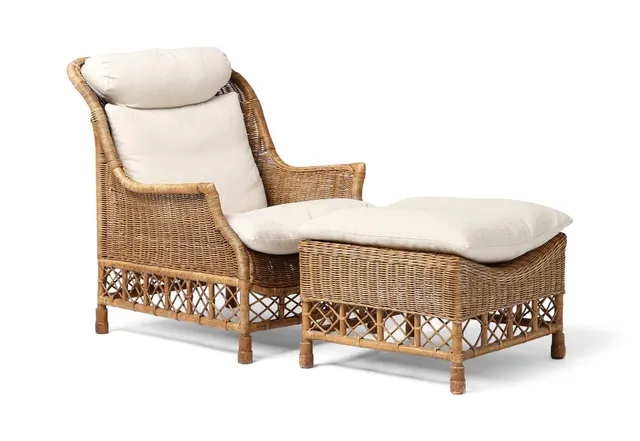 “Karen Blixen”. A woven rattan lounge chair and ottoman. Loose cushions upholstered with light fabric. Manufactured by Søren Lund Møbler. (2)
