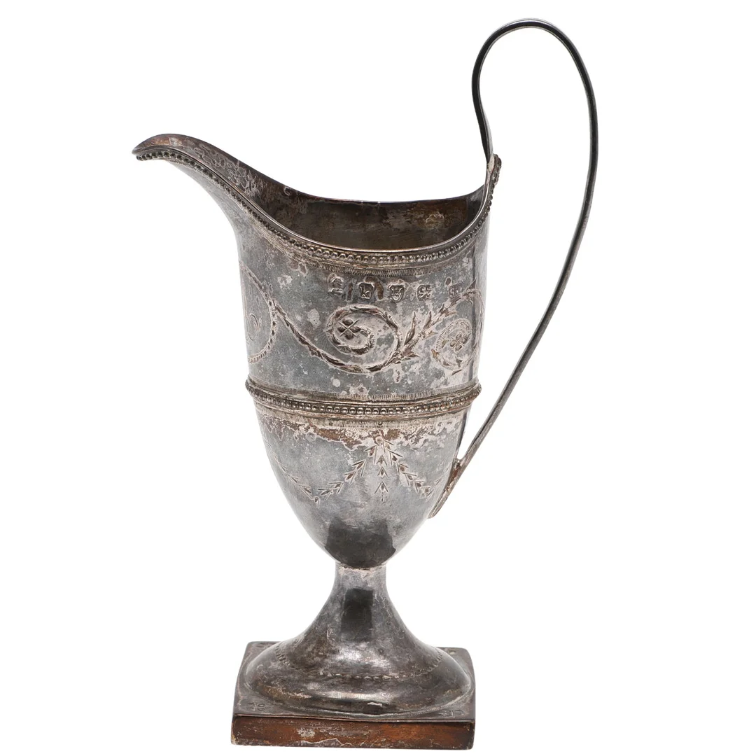 A GEORGE III SILVER HELMET CREAM JUG. — Silver — Lawrences Auctioneers