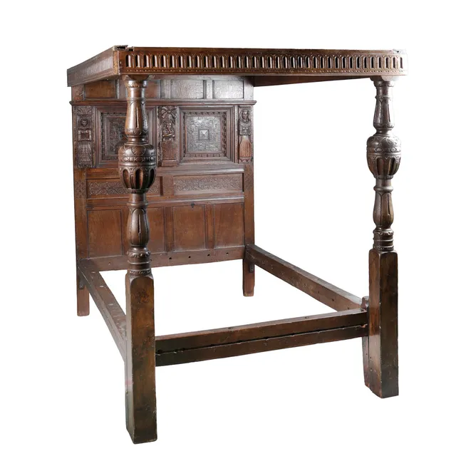 A 17TH CENTURY CARVED OAK TESTER BED.