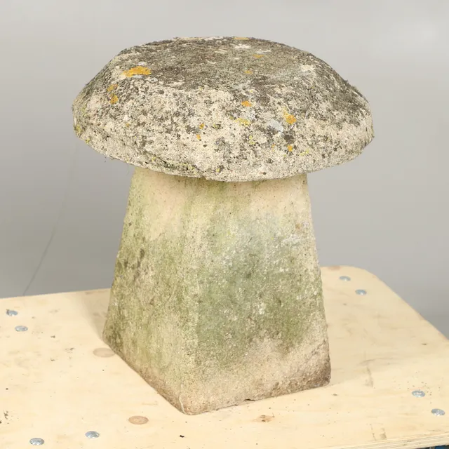 A RECONSTITUTED STONE STADDLE STONE.