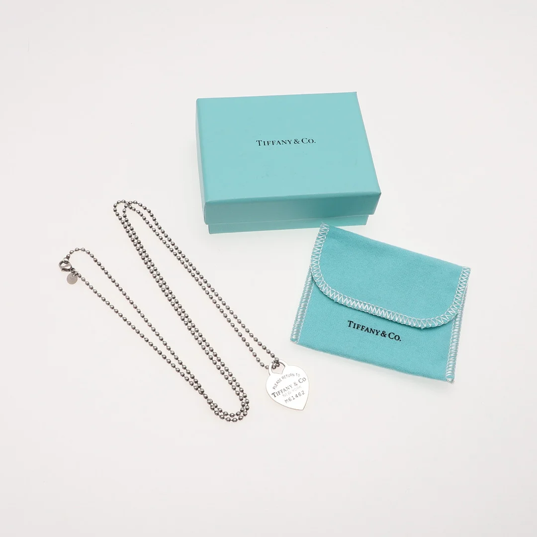 A TIFFANY & CO SILVER HEART PENDANT AND CHAIN. — Necklace — Lawrences Auctioneers