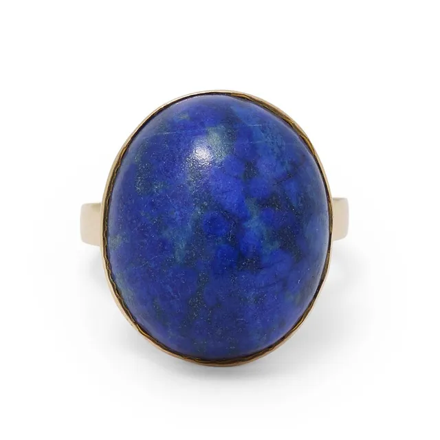 A lapis lazuli ring set with a cabochon lapis lazuli, mounted in 18k gold. Weight app. 10.8 g. W. 18 mm. Size 58.