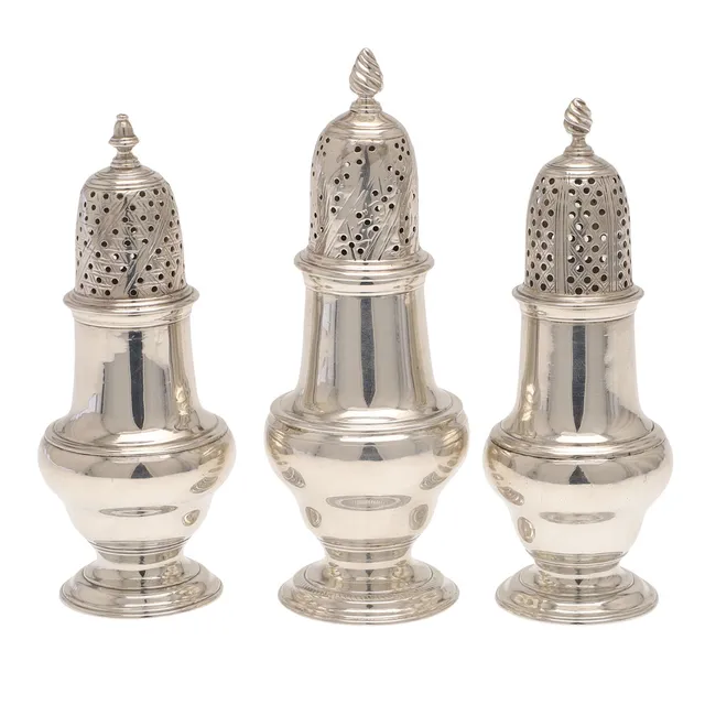 THREE GEORGE III SILVER PEPPER CASTERS.