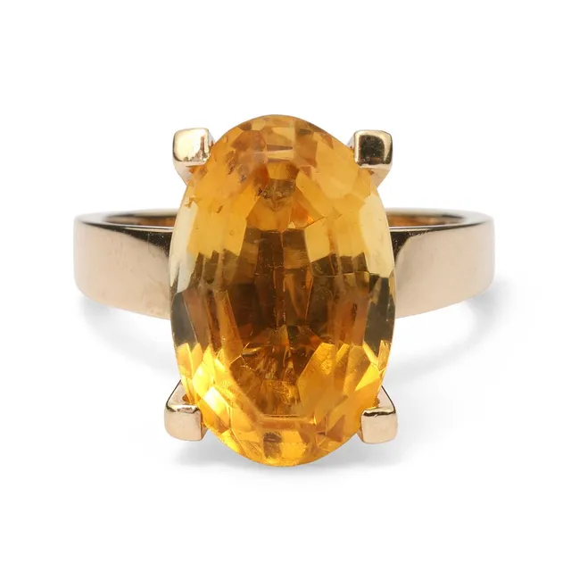 A citrine ring set with an oval-cut citrine mounted in 18k gold. Weight app. 7.2 g. W. 15 mm. Size 55.