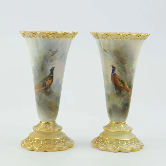 A ROYAL WORCESTER PAIR OF SMALL VASES.
