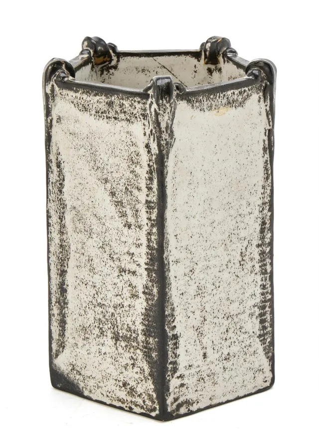 Pentagonal earthenware vase with moulded relief decoration. Decorated with black and white ash glaze. Signed HAK, stamped Denmark. Made by Kähler. H. 21.3 cm. W. max. 15 cm.