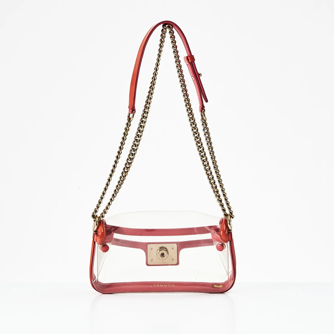 CHANEL, "Naked Boy Flap Bag", 2012-2013, axelbandsväska i genomskinlig vinyl (PVC) med kantband i korallrosa/laxrosa, detaljer i gulmetall, framsida med s.k. CC push-lock closure. — Vintage & Designer Fashion — Stockholms Auktionsverk Magasin 5