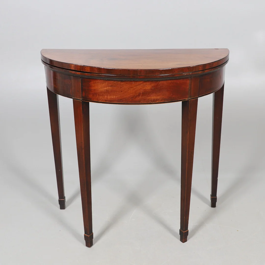 A NINETEENTH CENTURY MAHOGANY DEMILUNE CARD TABLE. — Tables — Lawrences Auctioneers