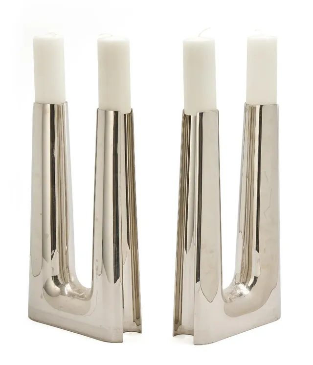 A pair of large stainless steel candelabra with two candle holders. Made and marked for Georg Jensen, Denmark. H. 43.8 cm. W. max. 24.5 cm. Inner diam. of candle holders 6 cm. (2)
