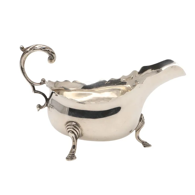 AN EDWARD VIII SILVER CREAM JUG.