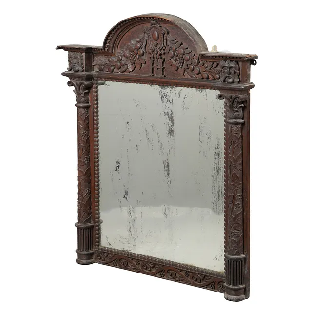 A VICTORIAN OAK FRAMED MIRROR.