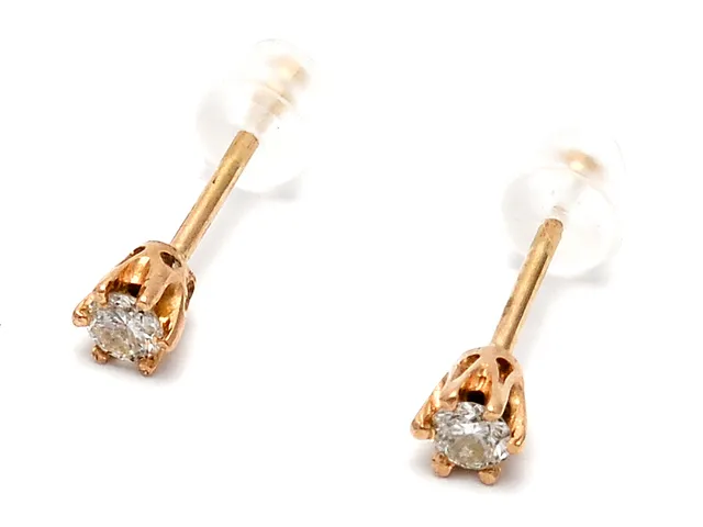 Örhängen ett par 18K 0,5g med diamanter 2xca0,05ct stoppers i plast