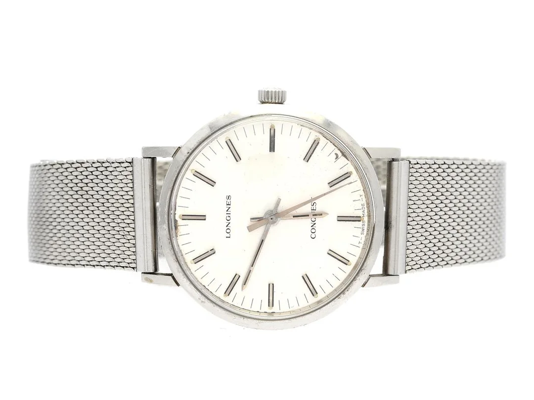 LONGINES, Conquest (T Swiss Made T), herrur, 35 mm, Cal 6942, Serie nr. 52123802, Boett nr. 1504.1 / 6942 / 16 / 657651, stål, manuell, plexiglas, skadad urtavla, defekt (fjäder av, behov av service), ca 1975, metallänk ej original. — Klockor/Longines — Kaplans