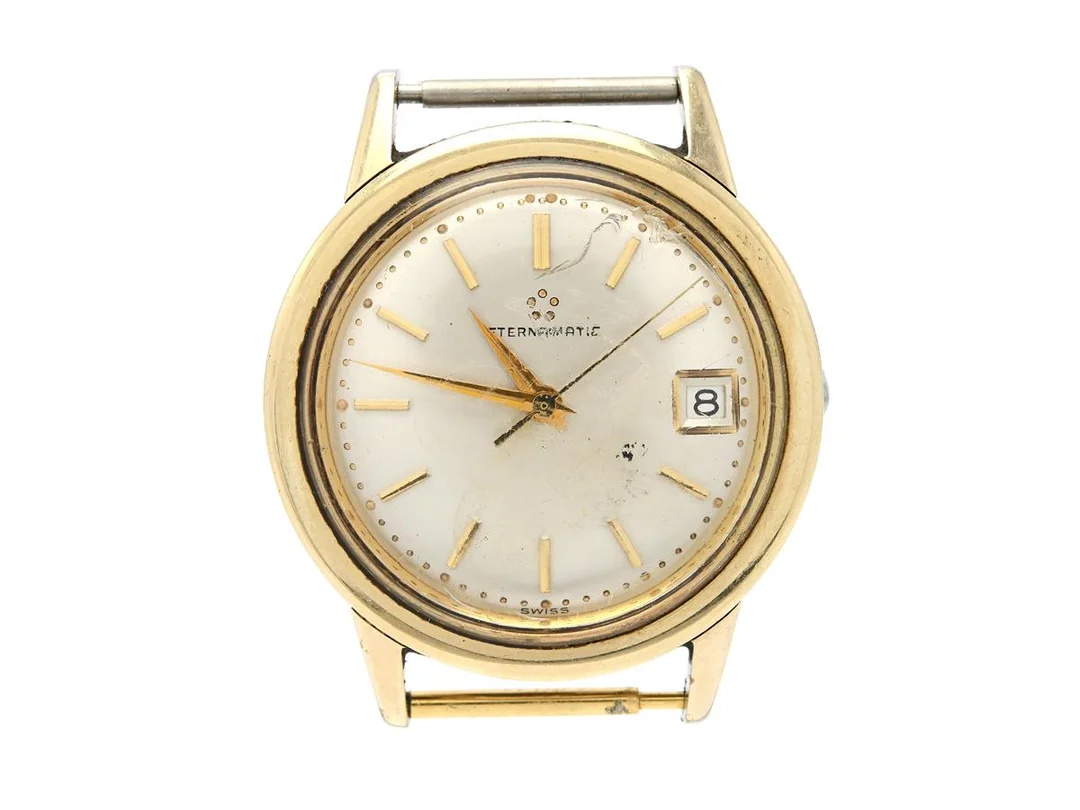 ETERNA-MATIC, herrur, 34,5 mm, Boett nr. 4440140, guld på stål, automatisk, plexiglas (skadat), datum, defekt (servicebehov), skadad krona, ca 1960. — Klockor/Eterna — Kaplans