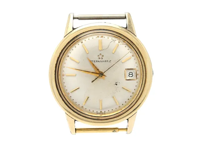 ETERNA-MATIC, herrur, 34,5 mm, Boett nr. 4440140, guld på stål, automatisk, plexiglas (skadat), datum, defekt (servicebehov), skadad krona, ca 1960.