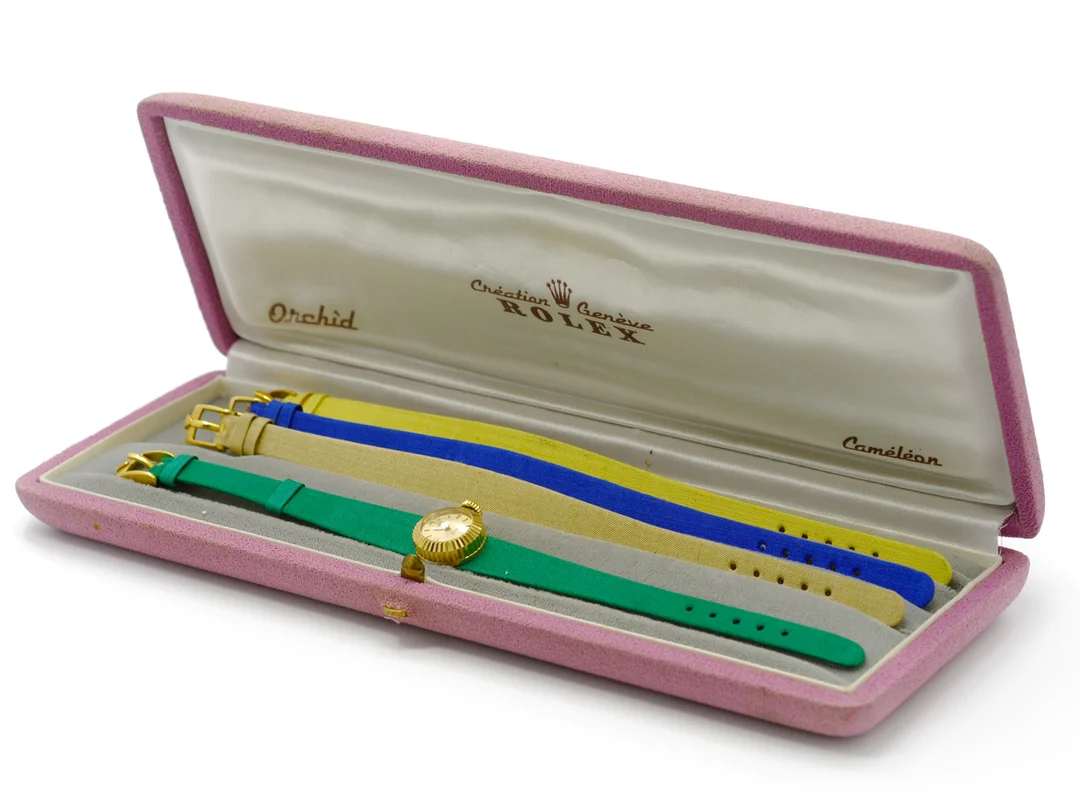 ROLEX, Orchid, Caméléon, Ref nr. 9303, damur, 16 mm, 18K guld, manuell, safirglas, skadad urtavla (9/10), defekt, 4 st. textilband med originalspännen, ca 1960, box. — Klockor/Rolex — Kaplans