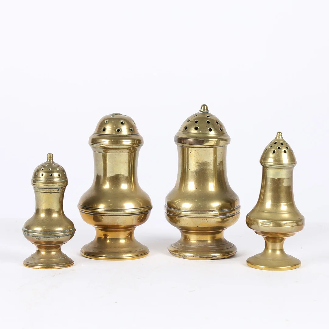 A GROUP OF FOUR GEORGE III CAST BRASS CASTERS OR PEPPERETTES, CIRCA 1780-1800. — Pewter, Brass & Copper — Bishop & Miller