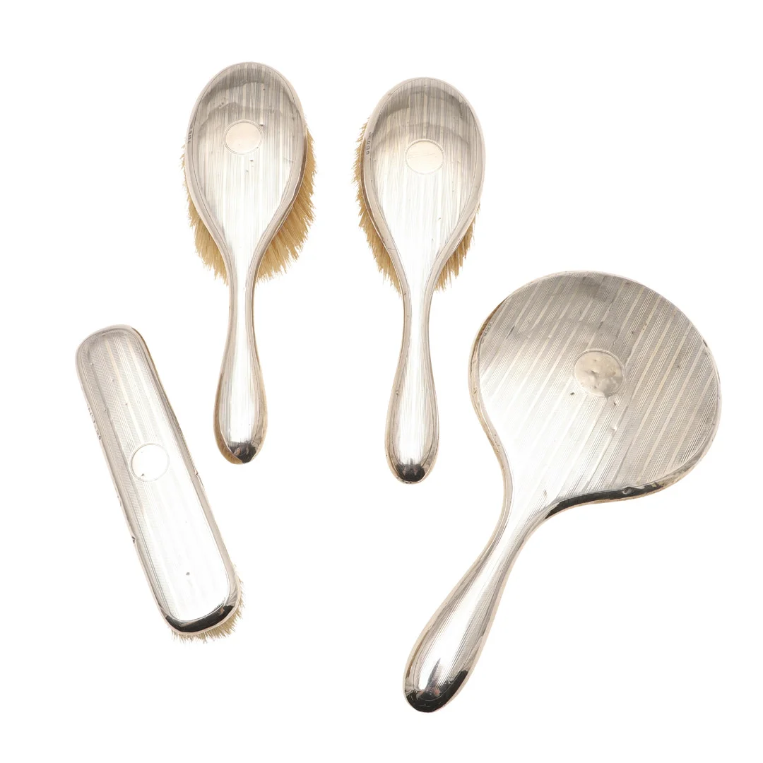 A FOUR PART SILVER BACKED DRESSING TABLE SET. — Silver — Lawrences Auctioneers